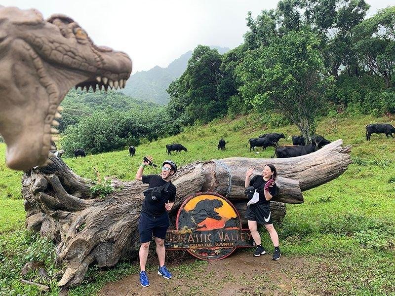 Tour guests at a Jurassic Valley dinosaur sign